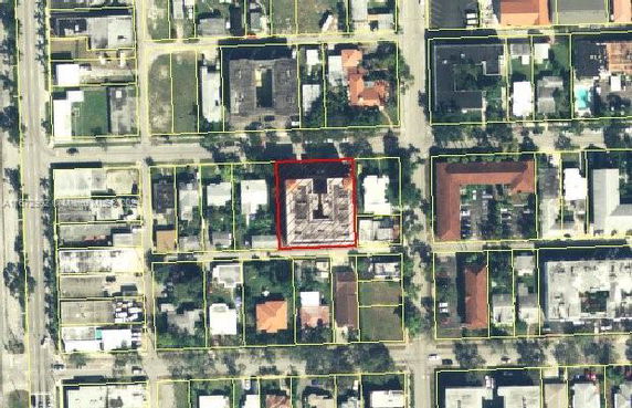 Aerial view of a city block with multiple buildings and streets.