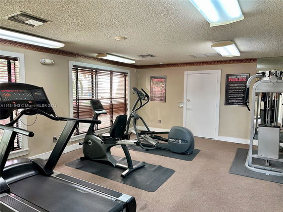 Indoor gym area with exercise equipment including treadmill and stationary bike.