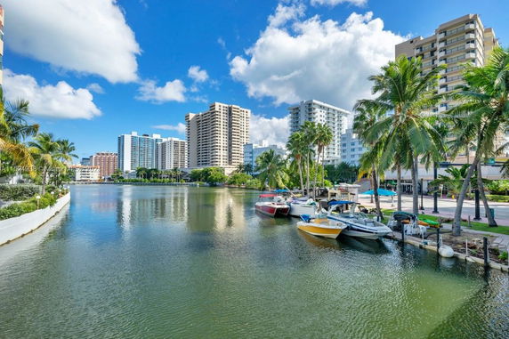 View of waterfront with boats and residential buildings.