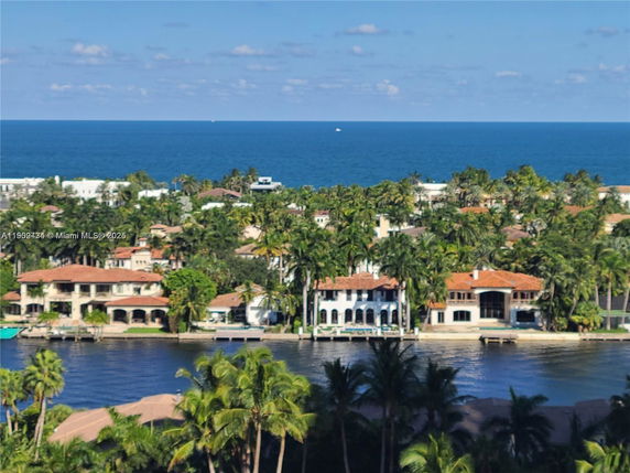 Panoramic view of waterfront homes with a backdrop of the ocean.