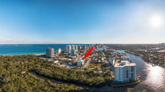 Panoramic view of a coastal cityscape with buildings and ocean.