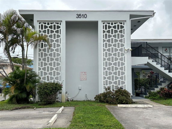 Front view of a two-story building with decorative facade panels.
