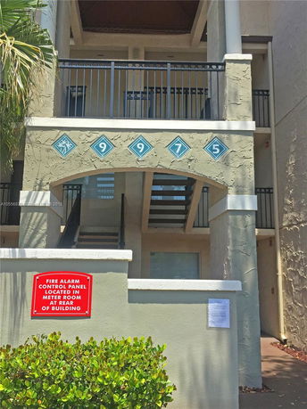 Front view of a multi-story building with staircases and balconies.