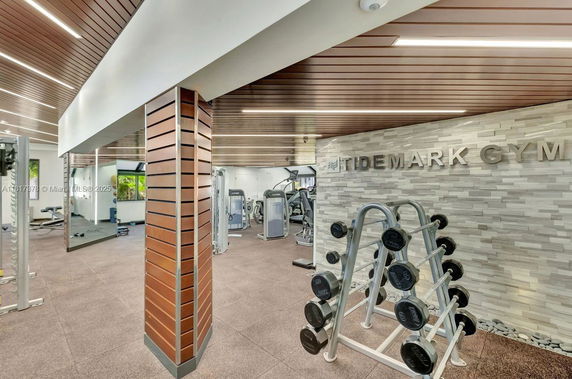 Indoor view of a gym with exercise equipment and a wall labeled 'Tidemark Gym.'