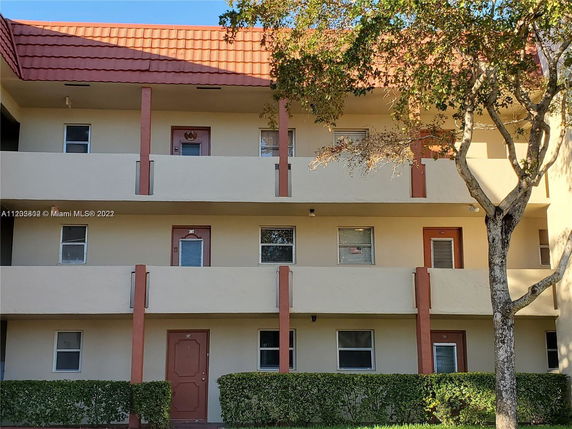 Front view of a multi-story residential building with balconies.