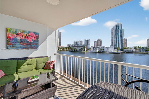 Balcony view overlooking water and surrounding buildings.