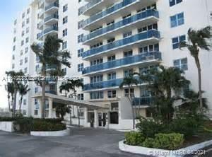 Front view of a multi-story apartment building with balconies.