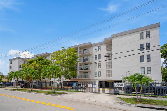 Front view of a multi-story residential building with balconies.