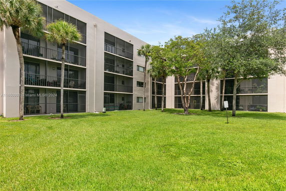 Front view of a multi-story residential building with balconies.
