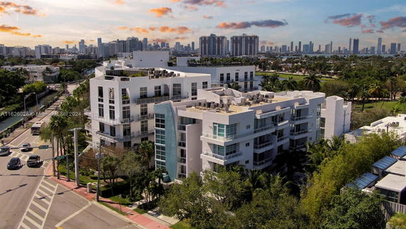 Front view of a multi-story modern apartment building with balconies.
