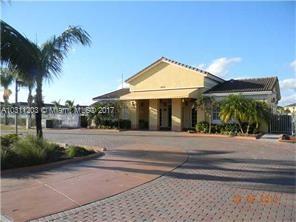 Front view of a single-story house with a tiled roof and driveway.