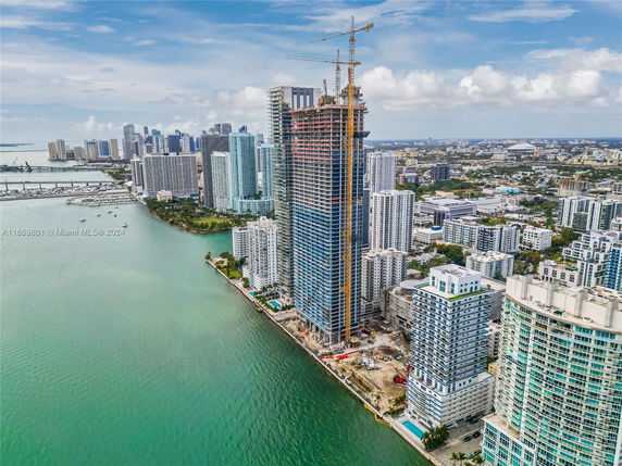 Panoramic view of high-rise buildings along a waterfront in a city.