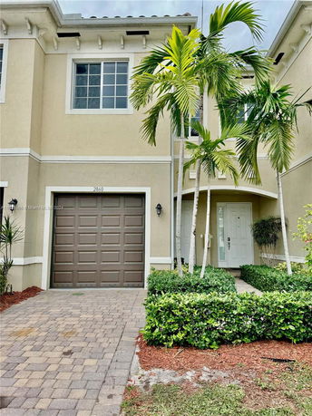Front view of a two-story house with a garage and entrance.