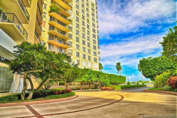 Front view of a multi-story apartment building with balconies.