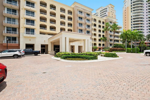 Front view of a multi-story residential building with a prominent entrance.