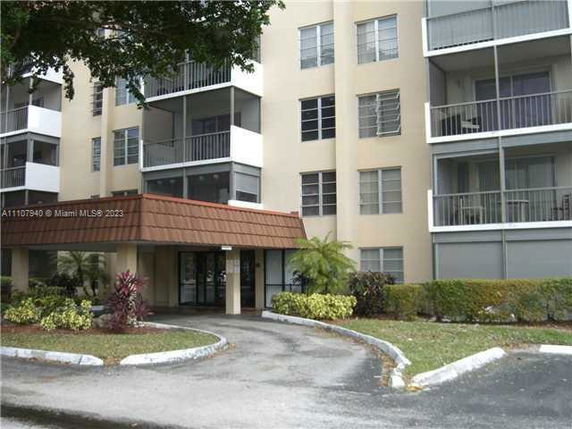 Front view of a multi-story residential building with balconies.
