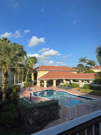 View of a swimming pool area with surrounding buildings.
