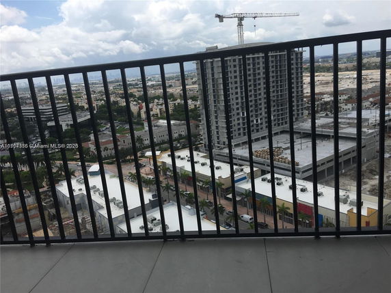 Panoramic view from a building showing surrounding urban area and construction sites.