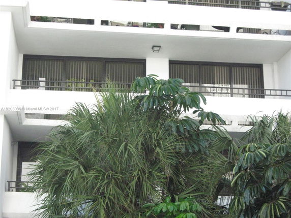 Front view of a multi-story building with balconies.