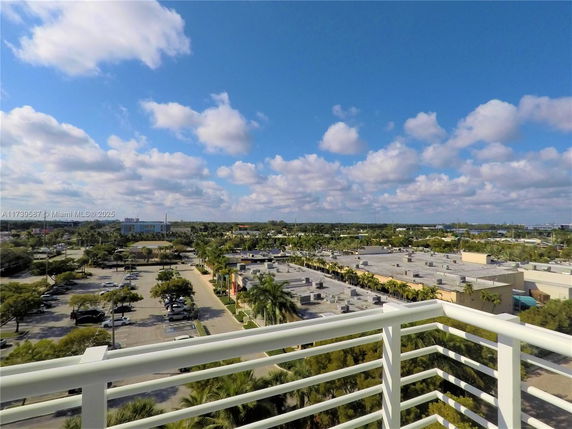 Panoramic view from a high vantage point showing a parking area and surrounding buildings.