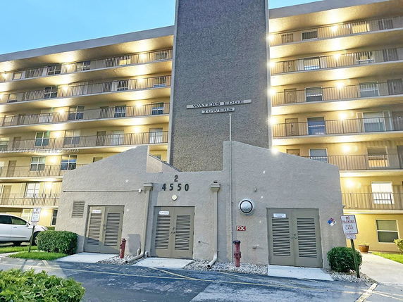 Front view of a multi-story residential building with balconies.