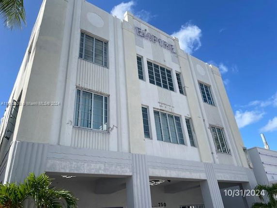 Front view of a multi-story building with large windows and an Art Deco design.
