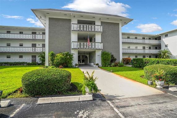 Front view of a multi-story residential building with balconies.