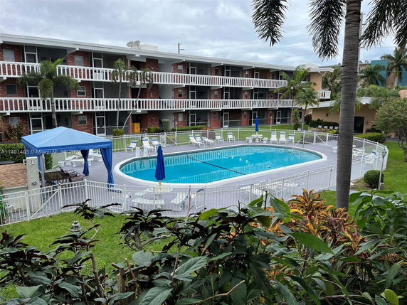 Swimming pool area with surrounding apartment buildings.