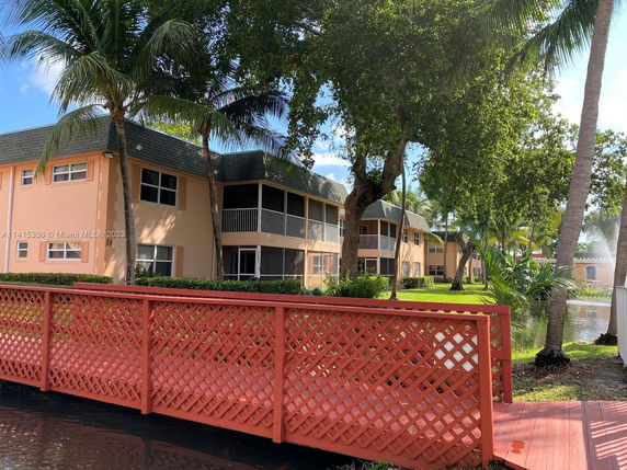 Front view of a two-story apartment building with screened balconies.