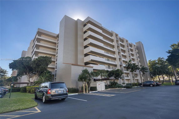 Front view of a multi-story residential building with balconies.