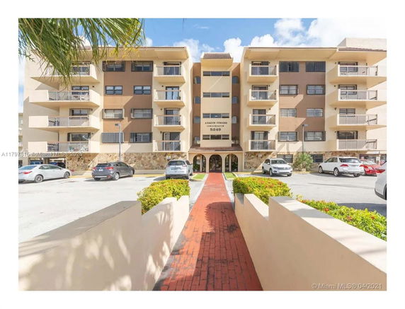 Front view of a multi-story residential building with balconies.
