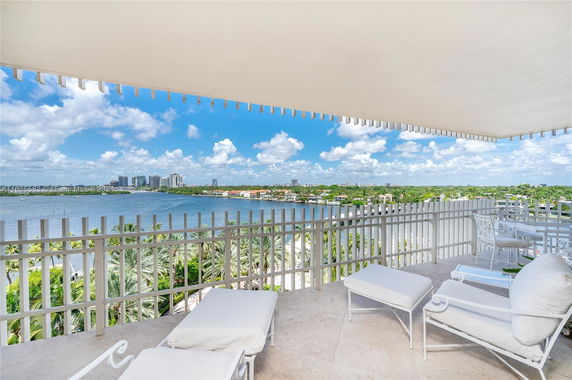 Panoramic view from a balcony overlooking a river and cityscape.