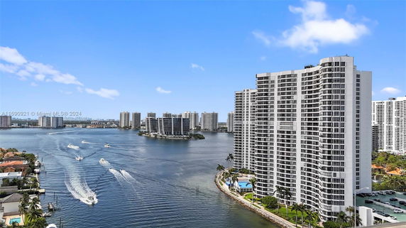 View of high-rise buildings near a body of water with boats.
