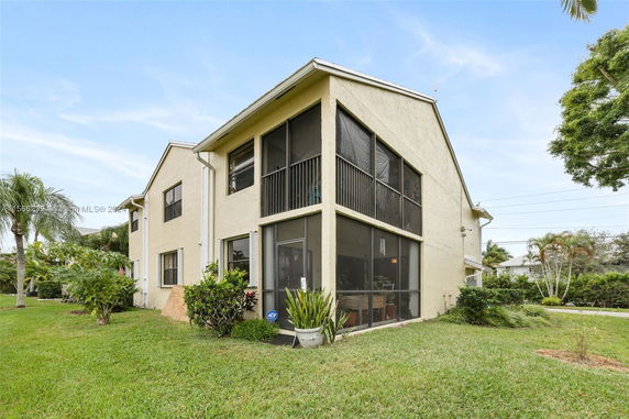 Front view of a two-story house with screened-in balconies.