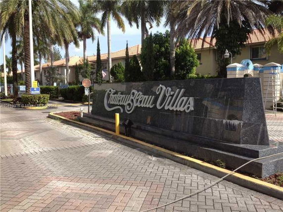 Front view of a building entrance with a sign that reads 'Chateau Beau Villas'.
