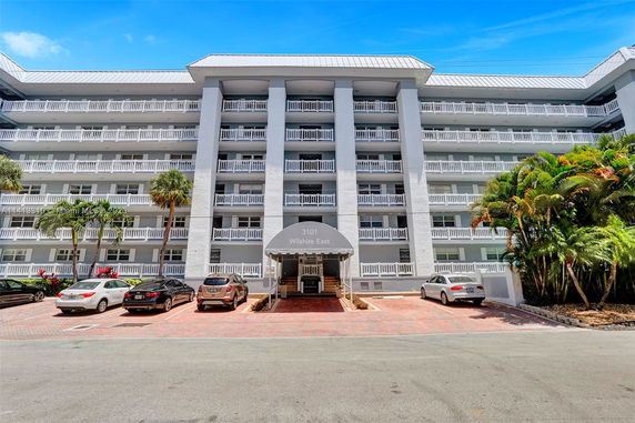 Front view of a multi-story building with balconies.
