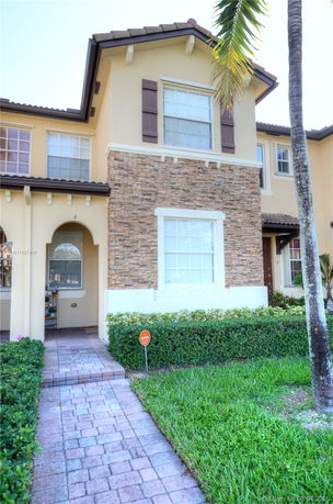 Front view of a two-story house with stone and stucco exterior.