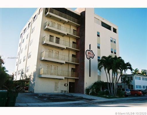 Front view of a multi-story apartment building with balconies.