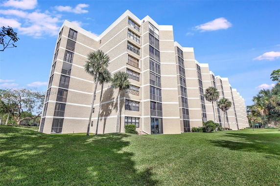 Front view of a multi-story residential building with balconies.