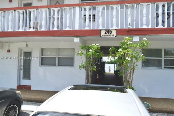 Front view of a multi-story building with a parking area.