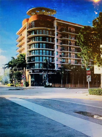 Front view of a multi-story building with large windows and balconies.