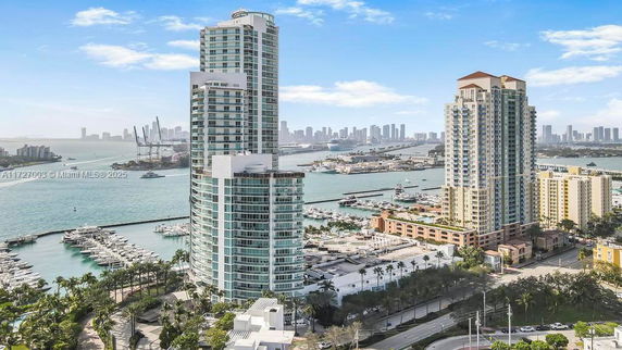 Panoramic view of modern high-rise buildings by a marina.