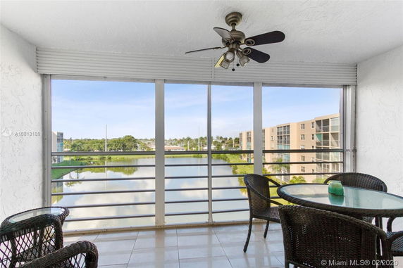 View from a balcony overlooking a scenic area with buildings and water.