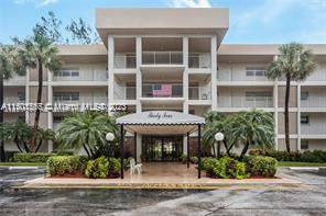 Front view of a multi-story building with a covered entrance.