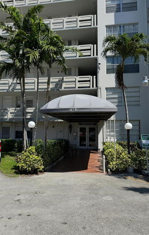 Front view of a multi-story building entrance with a canopy.
