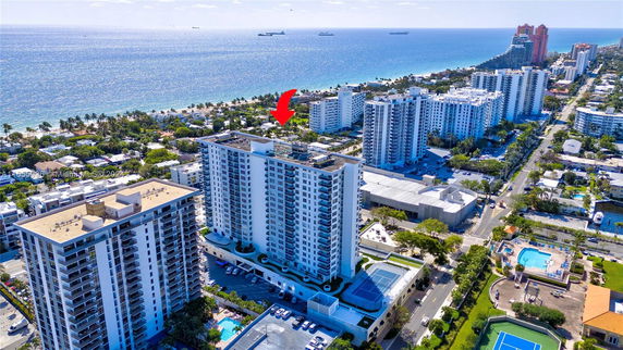 Aerial view of a coastal city with high-rise buildings and ocean in the background.