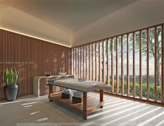 Indoor spa area with massage table and wooden slat walls.