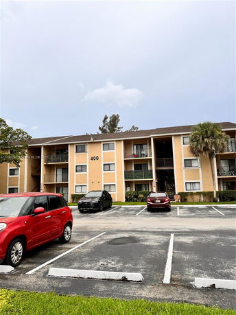 Front view of a multi-story apartment building with balconies.