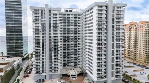 Front view of a high-rise residential building with balconies.