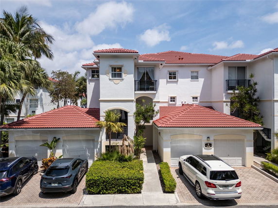 Front view of a multi-story house with red roof tiles and a double garage.